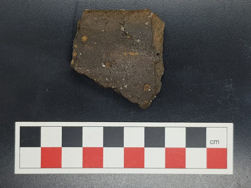 Rim sherd from an early Neolithic round-bottomed bowl, dated c3800-3600BC found within a ditch of a Neolithic Mobnument in Stringmans field