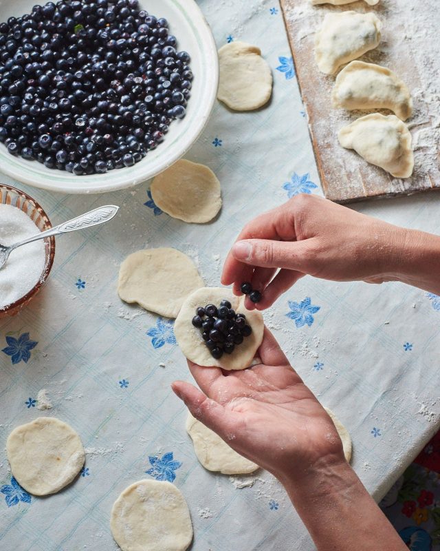 Making Varenyky filled with blueberries
