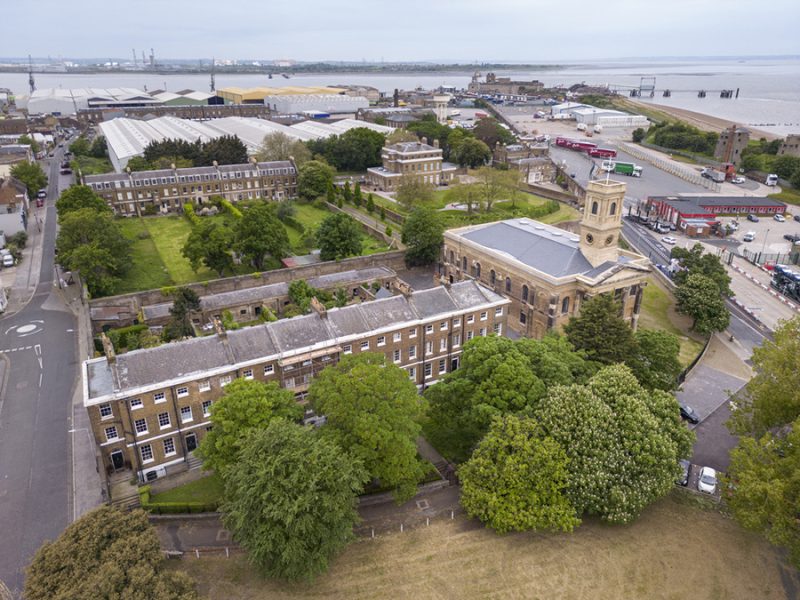 An overhead view of Dockyard Church, Naval Terrace and the naval officers houses in the dockyard looking over to Southend, Essex