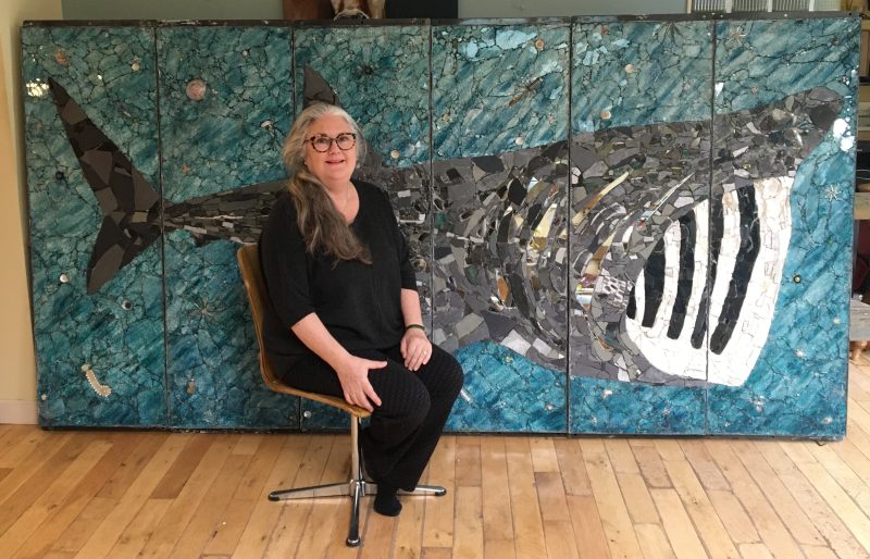 Kimmy McHarrie in front of her mosaic of a basking shark at Ronaldsway Airport, Isle of Man