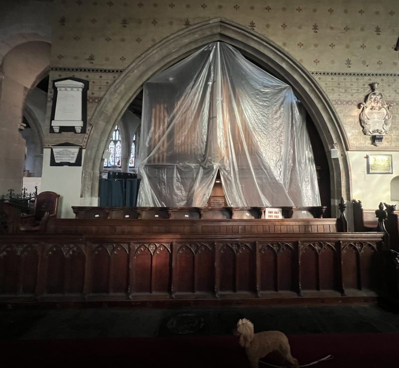 Dustsheets protect the organ of Faversham church while work is carried out. The paintings are more inaccessible than ever