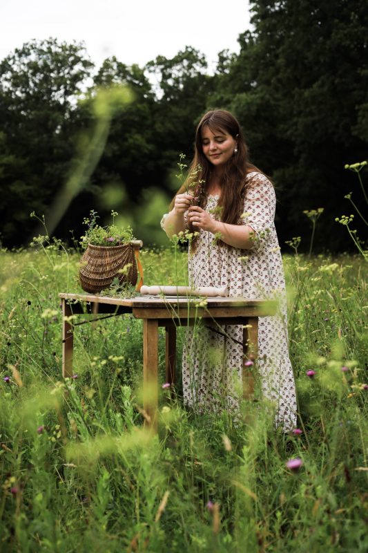 Forest Tozer gathering flowers and foilage to decorate her pottery