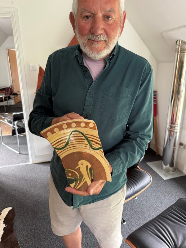 Dr Paul Wilkinson holds a shard of a medieval pot from archaeological excavations in Abbey Street, Faversham