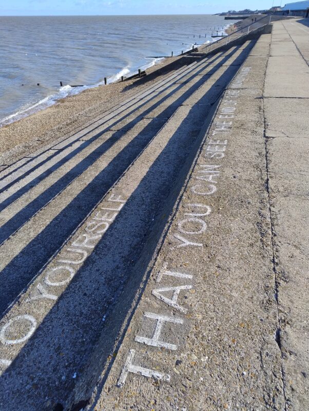 An uncredited poem is painted on the steps of the sea wall looking out to the wrecked masts of the SS Richard Montgomery