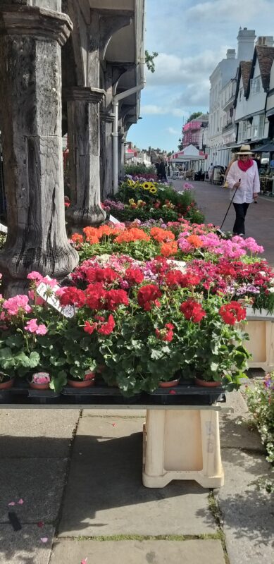 Banks of flowers among the pillars of the Guildhall